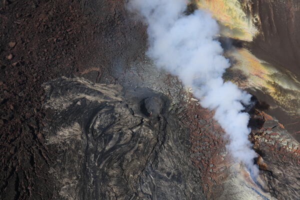 Color photograph of volcanic vent that is degassing