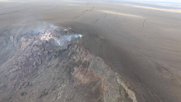 Color photograph of cliff covered with slumping volcanic deposits
