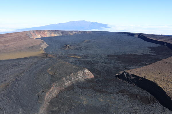 Color photograph of summit caldera at top of volcano