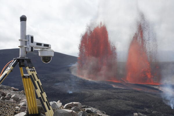 Color photograph of lava fountains and camera