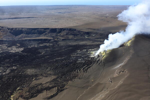 Color photograph of volcanic vents degassing within crater