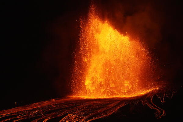 Color photograph of lava fountain at night