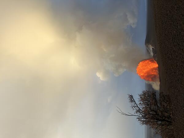 Color photograph of lava fountain in the distance