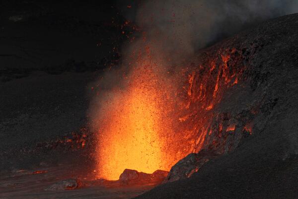 Color photograph of lava fountain at night