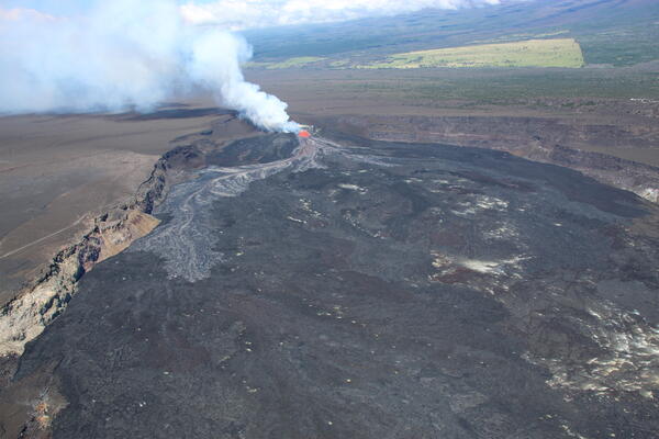 Color photograph of volcanic eruption within caldera
