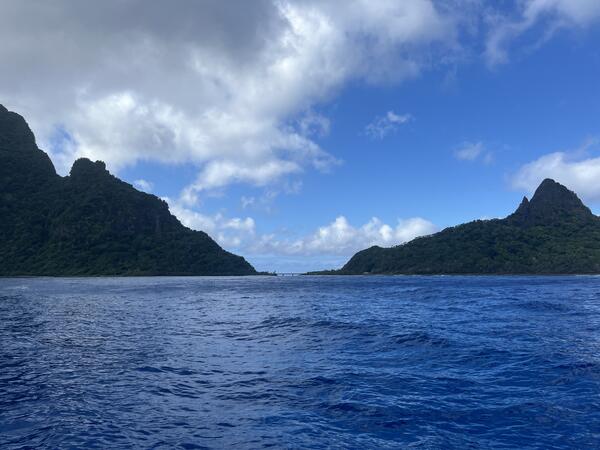 Color photograph of ocean in foreground, island in background