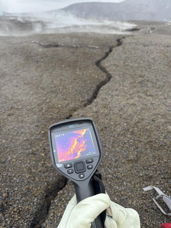Color photograph of thermal camera showing temperature of ground crack