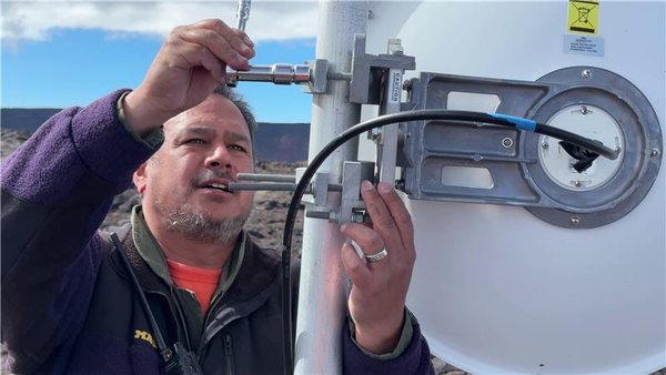 Color image of field engineer installing new antenna