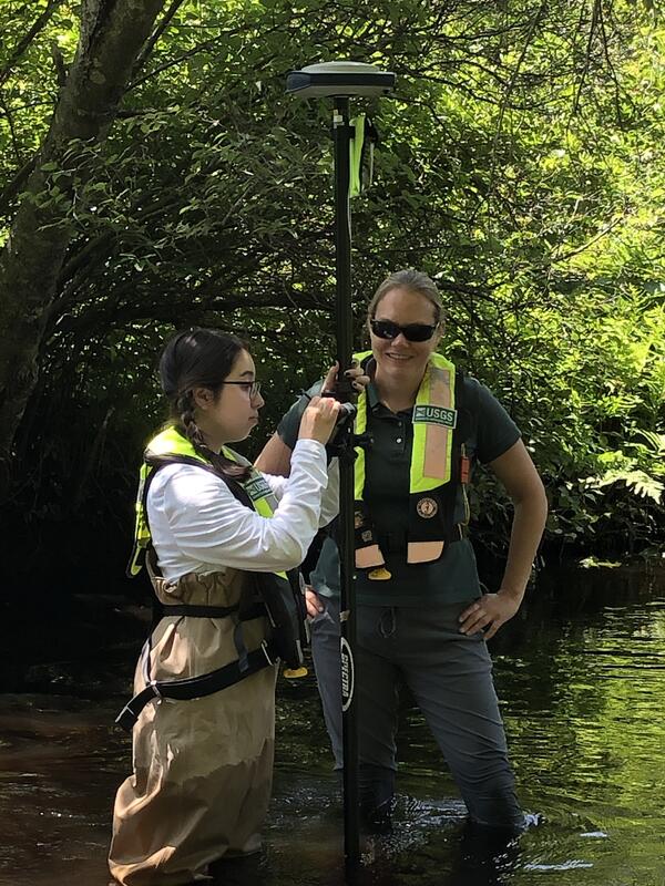 Research scientist Meagan Gonneea and USGS intern Angela Trejo survey the Jones River in Kingston, MA