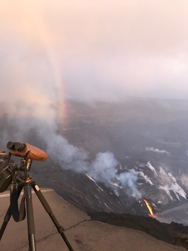 Color photograph of laser range finder, lava, and rainbow