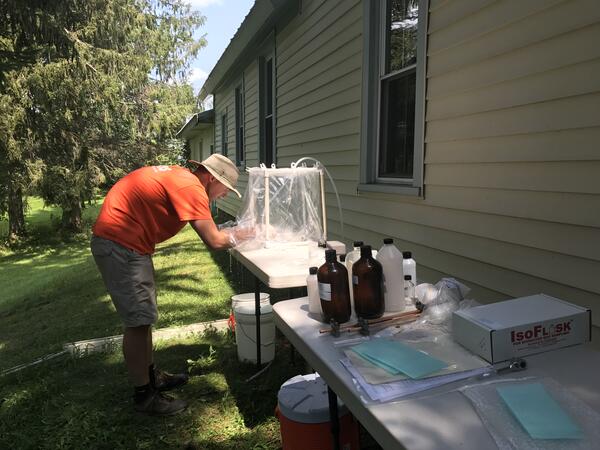Hydrologist collecting a water sample from a domestic well