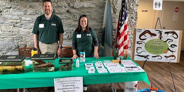 Two USGS employees with an exhibit about amphibians