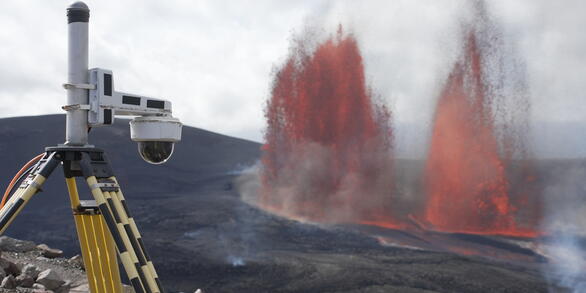 Color photograph of lava fountains and camera