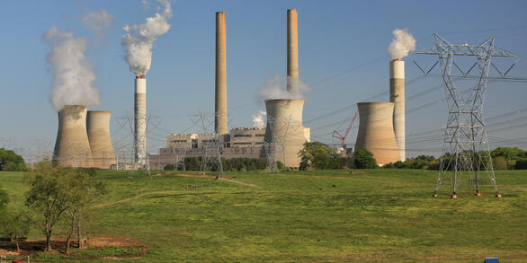 Thermoelectric power plant with cooling towers, smokestacks, and transmission towers