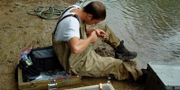 Dr. Nathan Johnson takes a non-invasive tissue sample of a freshwater mussel at the Green River, Kentucky