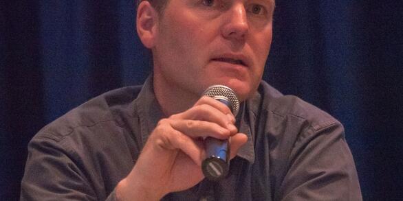 David Pilliod holding a microphone while speaking