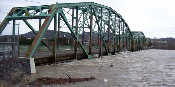 St. John River threatens to swamp a steel bridge.