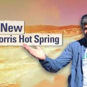 Man gesturing in front of a barren landscape with title "The New Norris Hot Spring"