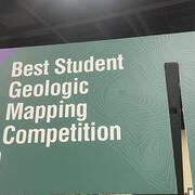 Large green rectangular sign reading "Best Student Geologic Map Competition"