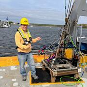 Person on ship pointing to equipment
