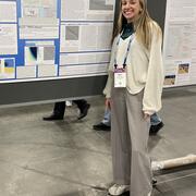 scientist standing next to poster