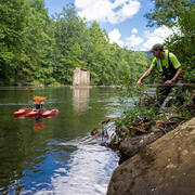 Eric Boyd pulls an Acoustic Doppler Current Profiler across a river.