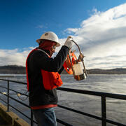 Hydrologic technician Fisseha Mengistu reels in a sampling bottle.