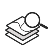 A stack of simplified maps with a magnifying glass on top