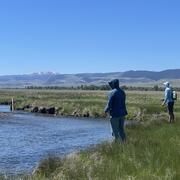 Two anglers on the banks of a river