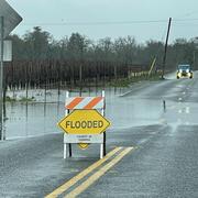 Flooded sign on a rainy road
