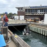 equipment being lowered into the water by people on a dock