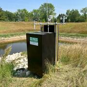 Constructed stormwater wetland upland native vegetation surrounding a USGS self-contained, solar-powered, monitoring station 
