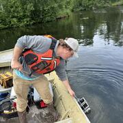 Graduate student is collecting substrate samples on Big Lake, Alaska