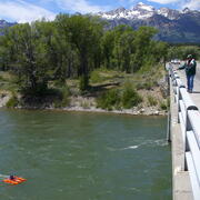 Hydrologist measuring at USGS Streamgage 13013650 near Moose, Wyoming from the bridge