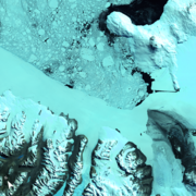 Satellite image showing birds eyes views of ice, snow and water in shades of blues and black