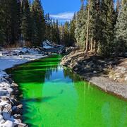 Image of green dye in water during dye tracer study on the Slate River