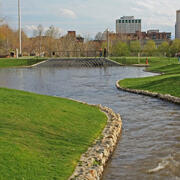 Photo of stream in urban environment with green lawn beside it. Photo credit: Alan Cressler USGS