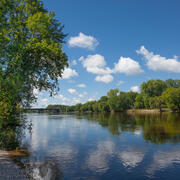 The Mississippi River above Minneapolis, showing a wide river surrounded by riparian vegetation
