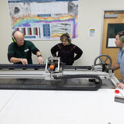 Scientists splitting a sediment core with the GeoTek core splitter