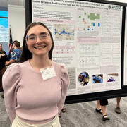 Physica Scientist, Amelia Ayers stands in front of her poster illustrating the transport of harmful algae in the Delta.
