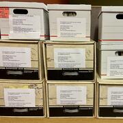 White and brown carboard boxes stacked on top of each other.