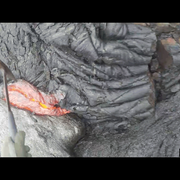 A repeating loop showing a hammer scooping lava from a flow and dropping it into a bucket.