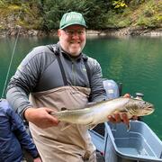 scientist holding fish on boat