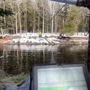 Hydrologic technician takes acoustic Doppler current profiler streamflow measurement from the center of a river via cableway
