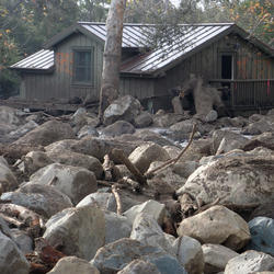 Home damaged by post fire debris flow