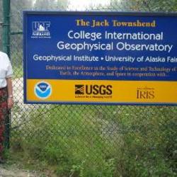 Sign posted with an older man standing next to it