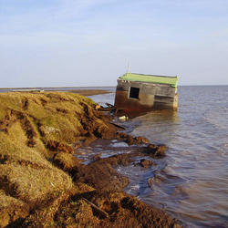 A cabin along Alaska's Arctic coast was recently washed into the ocean because the bluff it was sitting on eroded away.