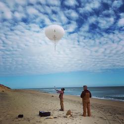 Jin-Si Over helping control the helium powered kite-balloon at Marconi Beach, Cape Cod National Seashore