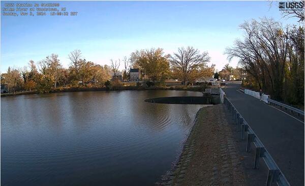 Looking across a lake at a Horseshoe Dam that leads out into the Salem River
