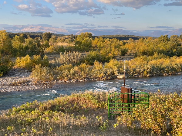 Streamgage on Birch Creek during fall, surrounded by cattle guards 